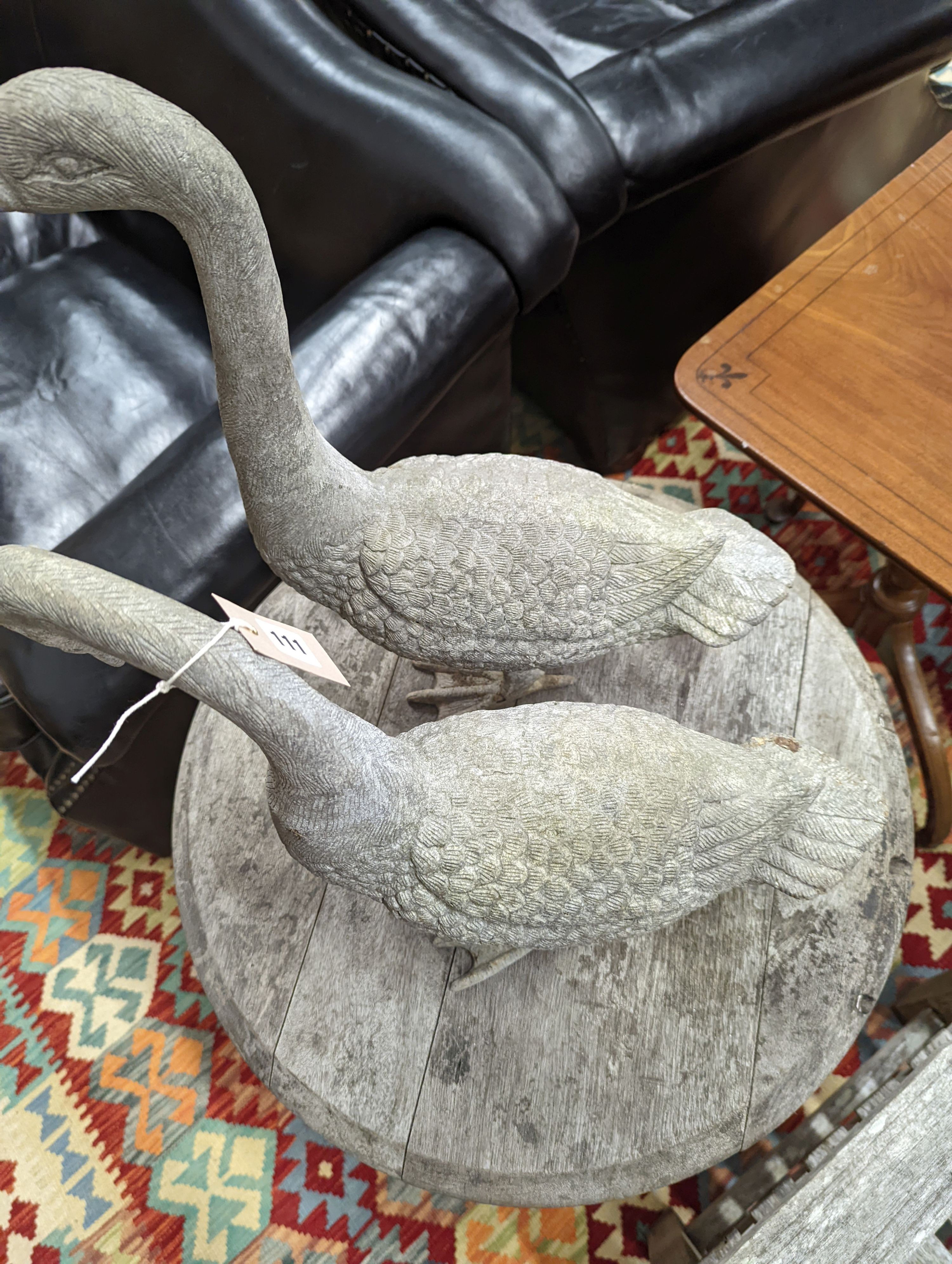 A pair of cast metal garden ornaments modelled as geese, larger height 51cm